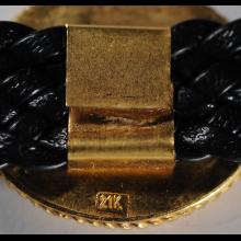 Bracelet or et cuir avec pi�ce en bronze